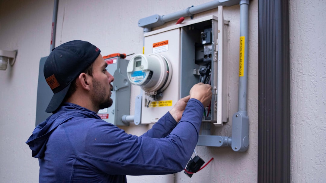 Professional electrician performing panel upgrade work