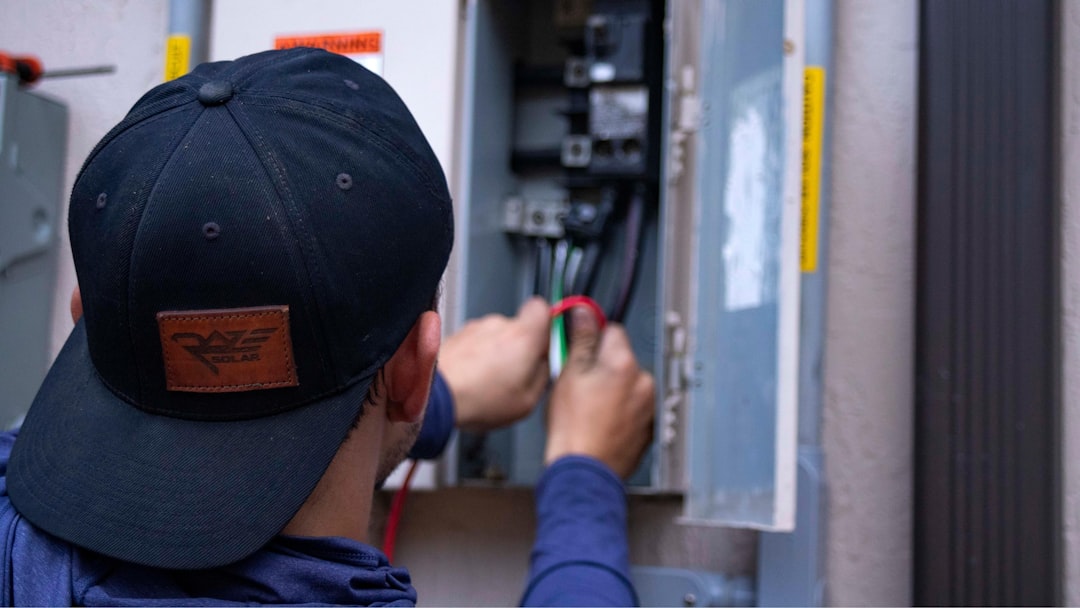 Certified electrician with professional installation tools and wiring equipment at a service location