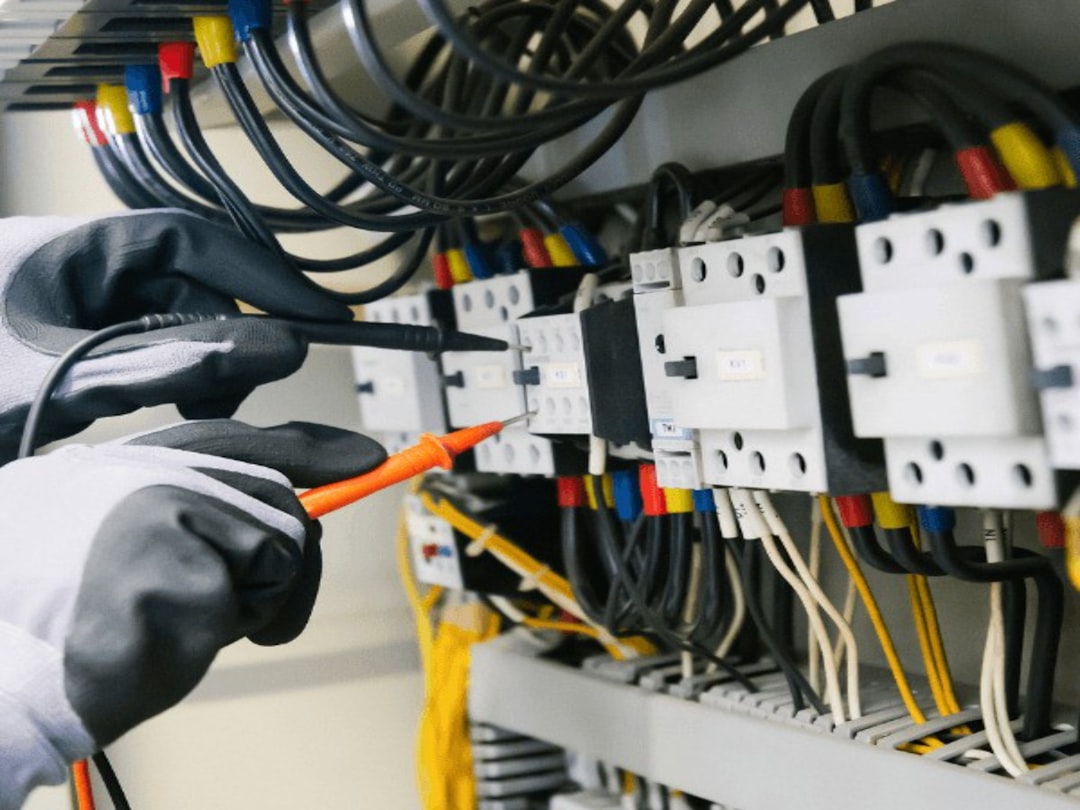 Professional electrician performing electrical wiring installation work with precision and expertise