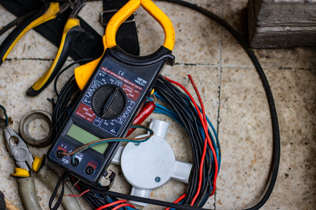 Professional electrician using multimeter for electrical diagnostics and testing work